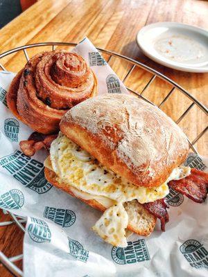 Bacon egg and cheese sandwich and cinnamon roll