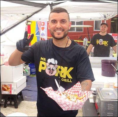 Mr. Chef gives me a friendly smile as he hands my basket of "Mr. Pork Sausage Loaded Fries" to me.