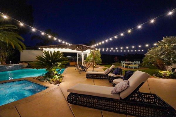 Cafe Lights strung over a backyard oasis