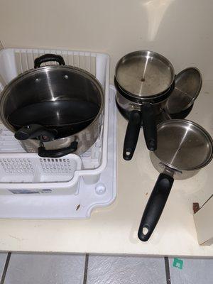 Pots and pans were old and unusable and there was a roach by the pots and pans.