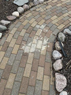 Concrete splatter all over brick walkways, fences