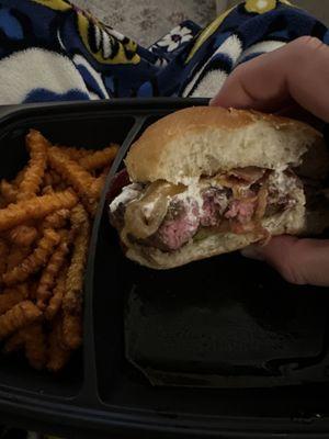 Flat river burger with goat cheese and sweet potato fries on the side.