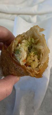 Interior of the egg roll. Was a little bland but tasty and not too oily. Perfect amount of wrapper too! Nicely chopped veggies inside.