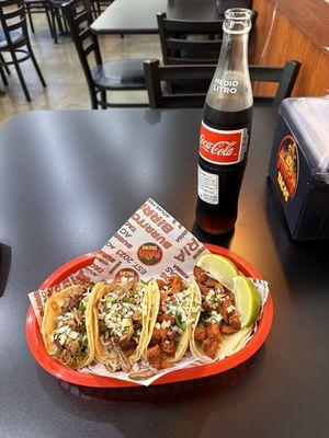 Two carnitas and two barbacoa tacos, and of course a glass bottle Coke!