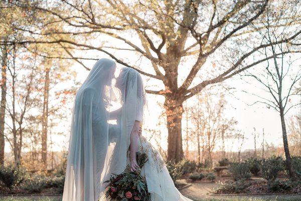 Bride and Groom autumn wedding in the mountains under veil eclectic Gothic wedding nose nuzzle