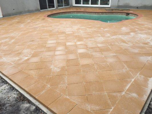 Thins pavers overlay around pool.