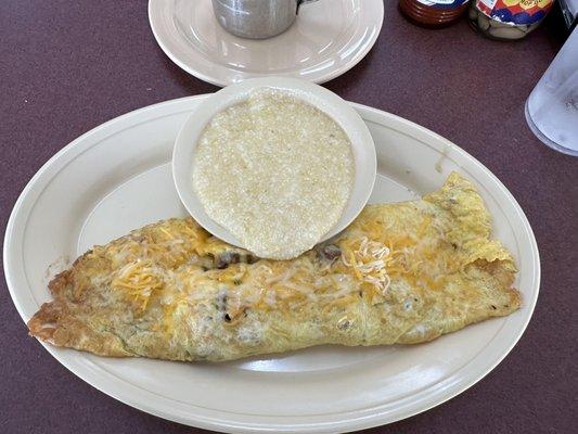 Breakfast from the menu: meat omelet with grits and toast