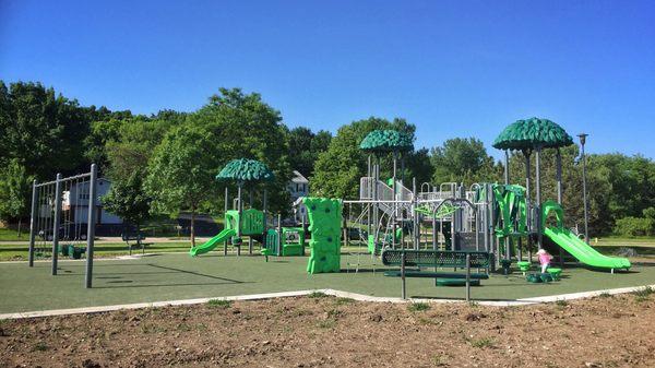 View of entire playground (swings, little kids and big kids).