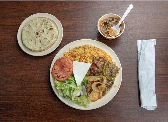 Aztec yellow rice, tomato salad, steak mixed with fajita blend and other spices