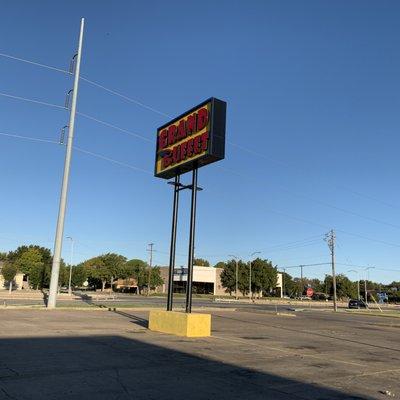 Sign for Grand Buffet with parking all around.