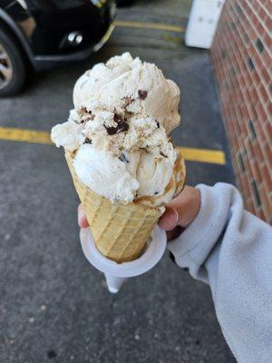 Coconut cheesecake brownie and peanut butter pie ice cream in waffle cone.