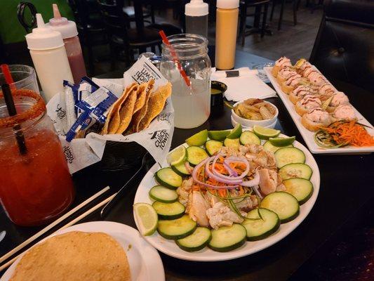 Raw scallops, sushi, michilada, and lemonade.