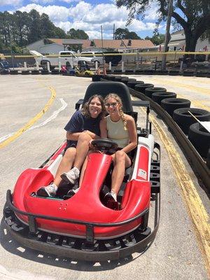 Maddie and Kirstin riding go-kart on a gorgeous day at OIB!