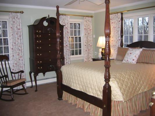 Pleated Draperies on Decorative Metal Rods. Quilted Coverlet, Gathered Bed Skirt, Tailored Shams.