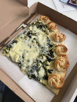 Spinach artichoke pizza with garlic knot crust