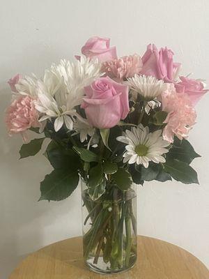 This charming bouquet is a combination of pink roses, pink carnation, and white daisies poms will put a smile to your friends and love ones.