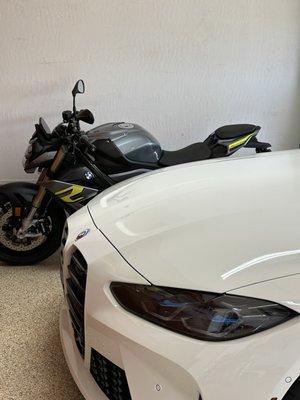 22023 BMW S1000R snoozing with 2023 BMW M4 Competition X-drive.