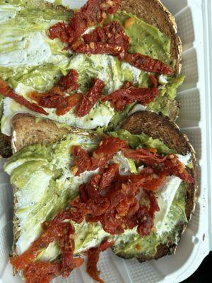 Avocado toast #1 with goat cheese and sundried tomatoes on oat toast