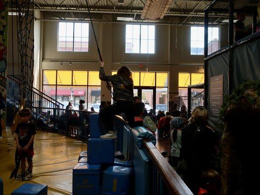 An airy place, and the busy waiting area for guardians in the background.