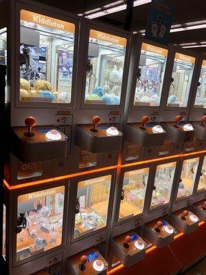 long row of gacha machines for small toys and demon slayer