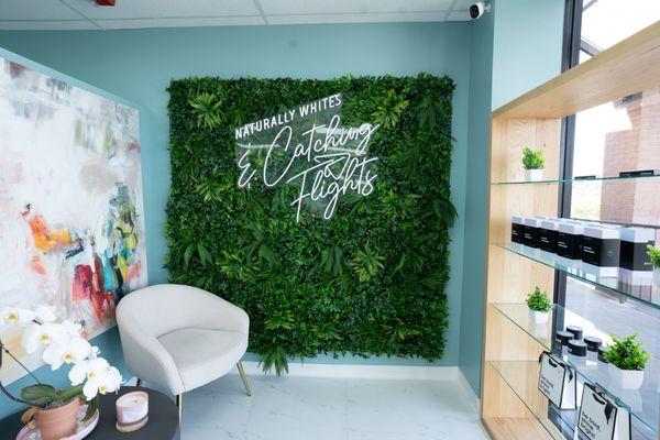 Front waiting area with our green wall for pic and content and our retail products