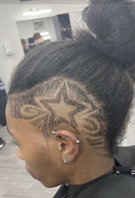 Female with an undercut and star-freestyle design.