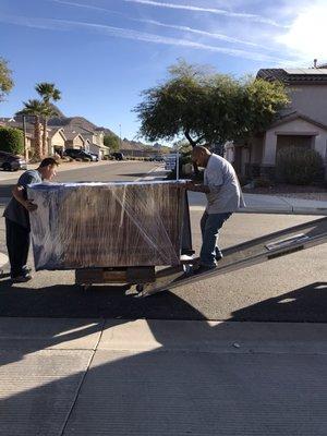 Heavy Armoire padded and shrink wrapped for protection moved by full time experienced employees.