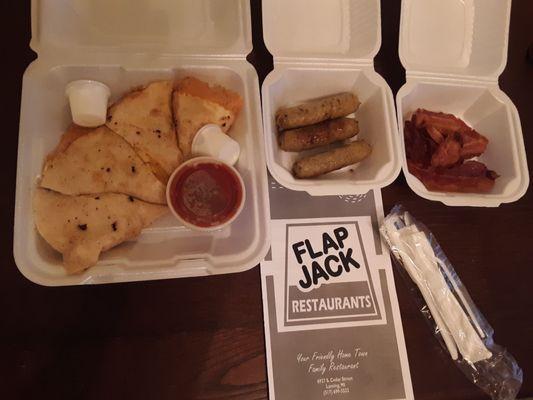 Takeout food is well packaged. A hearty, tasty breakfast quesadilla with salsa and sour cream. Side of sausage links and a side of bacon.