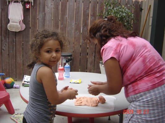 Doris working with the kids by making homemade play dough.