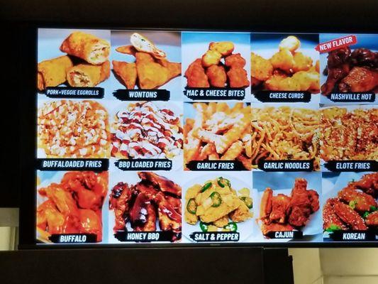 Photos on the menu board of some of their food. Wings, fries, sides