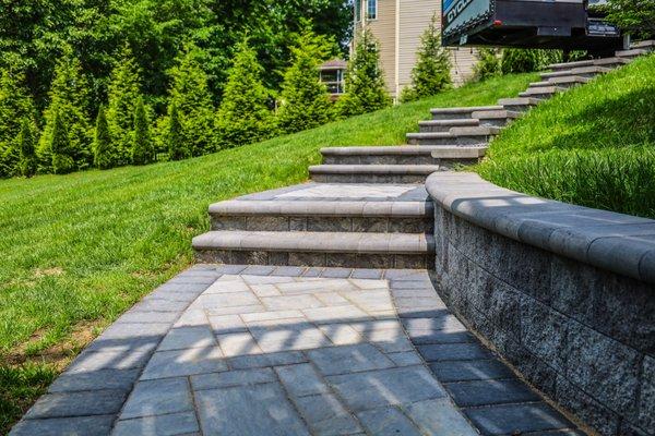 Paver steps with retaining wall installation.