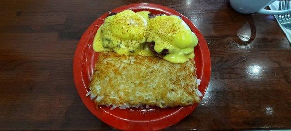 Irish eggs Benedict.  English muffins buried under corned beef, placed eggs, hollandaise sauce with stringed potatoes