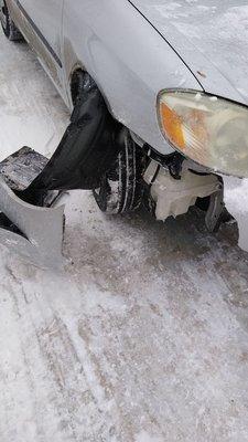 The damage to my car running into a snow bank.