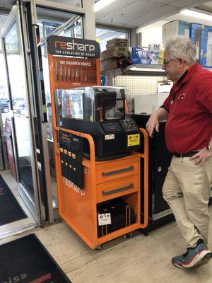 Friendly staffer Bob by their knife sharpening machine.