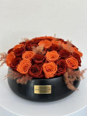 Welcome the magic of fall into your home with this stunning arrangement of fall-colored eternal roses, designed to last for years.