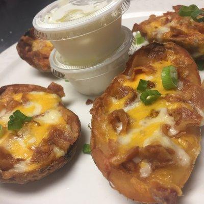 Potato Skins smothered in cheese and bacon topped with fresh scallions