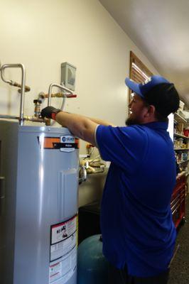 Our Plumber Jeshua working on a tank style water heater.