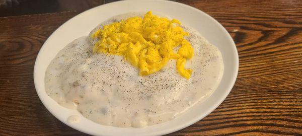 Biscuits and gravy topped with scrambled eggs. Delicious!