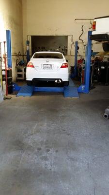 Car on the lift. Invidia Q300 freshly installed.