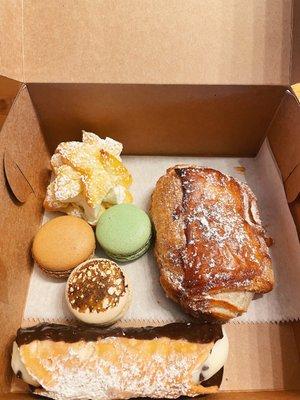 Cream puff, macarons (pistachio, coffee, crème brûlée), chocolate croissant, chocolate dipped cannoli