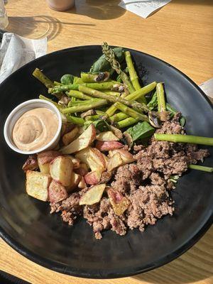 Bowl with ground bison, asparagus, potatoes & spinach with chipotle sauce