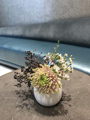 Table top arrangement with spider mum, berries, and wax flower.