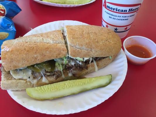 Philly cheesesteak (delicious!), with a small sample of hot sauce (liquid fire!) on the side. 1/2 tea & lemonade to drink.