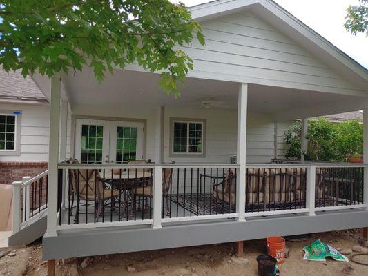 Custom covered deck. Composite deck boards with blend of composite railing and metal balusters. Finished roof with ceiling with fan.