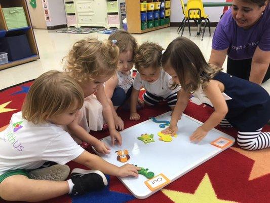 2 year olds taking attendance as they work in a group