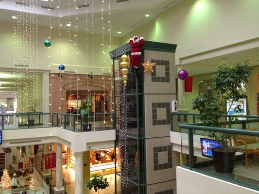 Santa climbing the elevator at Tanglewood Mall.