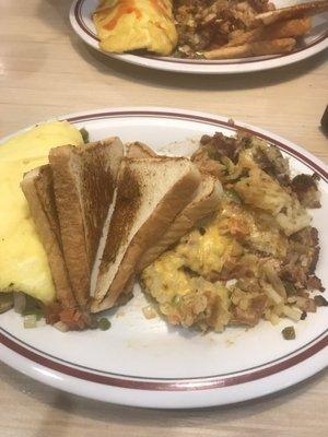 Veggie omelette with hash browns and whit toast.