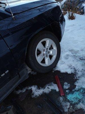 Bent front tire and pieces of the other guys bumper.