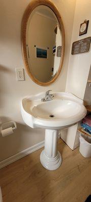 Installed pedestal sink in bathroom.