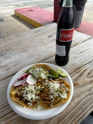 Shredded beef, chicken, and pork taco.